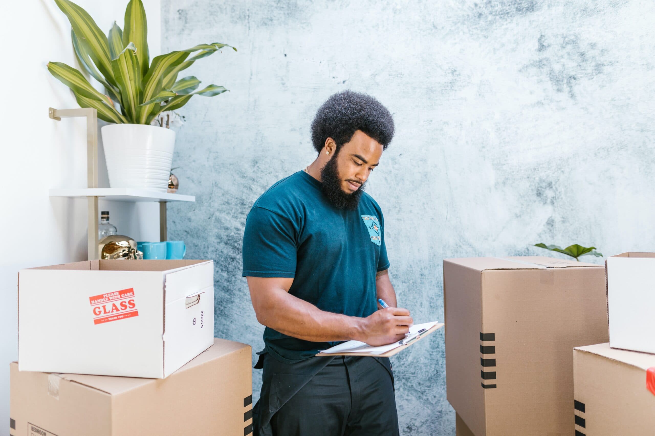 Professional mover carrying packed boxes